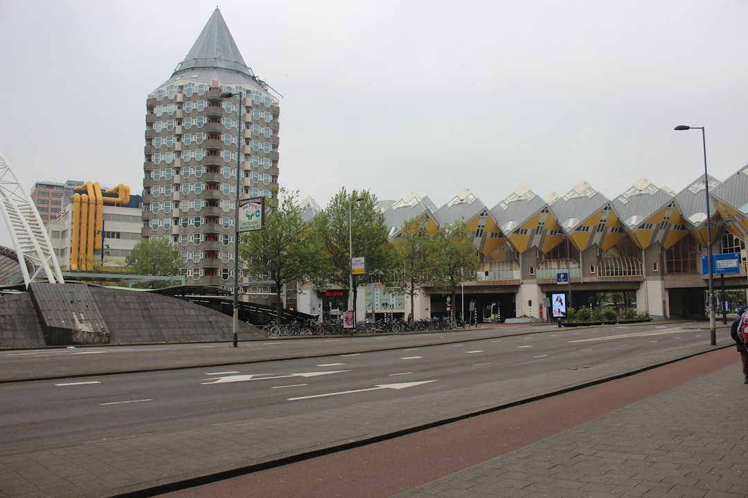 A car driving down a street next to tall buildings